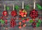 Red berries in copper pots on rustic wooden background. Summer gifts and harvest concept. Collage of different berries. Cherry,