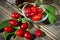 Red berries of cornel or dogwood with leaf ,and compote on a dark wooden