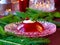 Red berries jelly on glass plate with christmas tree