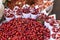 Red Berries topping with salt in paper cone at street local market in Darjeeling. India