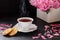 Red berry or fruit tea in teacup with peony