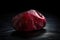 Red beryl is a rare precious natural geological stone on a black background in low key. AI generated