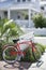 Red bicycle in front of house.