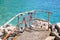 Red bicycle leaning on an iron fence in beach by sea. Bike leaning on railing on the pier facing adriatic sea horizon.