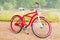 Red bike against stylized summer park landscape