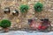 Red bike standing in front of stone wall in the italian ancient town. Tuscany. Pienza.