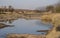 Red-billed Quelea Flock in Flight over a Water Hole