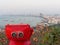 Red binocular on Pattaya beach showing explore and discover new place in tourism industry