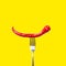 Red bitter chili pepper on the fork on yellow isolated background. Creative Food concept