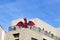 Red and Black blow up dragon on balcony of business building against blue sky for Halloween