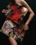 Red and black body paint. Woman with body art. Young girl with bodypaint. An amazing model with makeup.