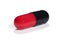 Red and black capsule with medicine