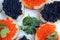 Red and black caviar of fish lies on wheat bread