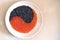 Red and black caviar laid on a plate