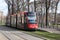 Red and black colored Avenio Siemens tram street car in the Hague Den Haag in the Netherlands.