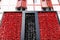 Red black Espelette peppers drying front of wall of typical Basque house