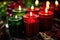 red, black, and green candles burning in a kinara