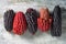 Red and black heirloom corn cobs on rustic wood surface