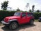 Red and black Jeep Wrangler parked in one Lima beach