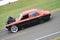 Red and black modified Drag Racing car with large powerful engine
