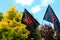 A red black patriotic Ukrainian flag with a red coat of arms of Ukraine flies during a demonstration. National symbol, resistance