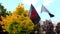 A red black patriotic Ukrainian flags with a red coat of arms of Ukraine fly during a demonstration in Dnipro city. National symbo