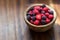 Red and black raspberries in a wooden bowl