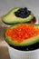 Red and black vegan caviar from kelp seaweed on avocado. Valuable and healthy product for a healthy diet. Superfood