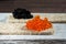 Red and black vegan caviar from kelp seaweed on crispbread. Valuable and healthy product for a healthy diet. Superfood. Close-up
