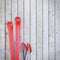 Red blank skis on wooden planks wall, winter background