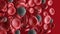 Red blood cells and coronavirus isolated on red background. Multiple objects. Erythrocytes.  COVID-19 pandemic.