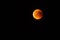 Red blood moon in the darkness of night lunar elipse