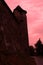 Red and bloody tower of a medieval fortress in Eastern Europe