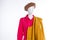 Red blouse and yellow coat on mannequin.