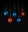 Red and blue balloons isolated in dark background, studio light, selective focus