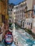 Red and blue boat in the canal of Venice, Italy