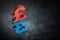 Red and Blue British Currency Symbol or Sign With Mirror Reflection on Dark Dusty Background