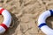 Red & blue buoys on  sand with copy space