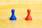 Red and blue chess pawn pieces, red pill and blue pill choice concept, pair of simple different opposing multi colored game pieces