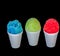 A red, blue and a green Hawaiian Shave ice desserts on a black background.