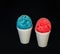 A red and blue Hawaiian Shave ice desserts on a black background.