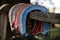 Red and blue horse shoes hanging off a fence post