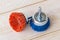 Red and blue nylon abrasive brushes for drill on a white wooden surface. Tools for cleaning, polishing and grinding of wood and