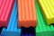 Red, blue,orange, green and yellow plastic clay sticks macro view