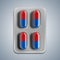 Red and blue pills in a blister on gray background