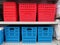 Red and blue plastic mesh organizer storage baskets