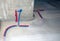 Red and blue plastic pipes for cold and hot water of the main supply home water system. Water plumbing heating tube coming out