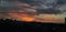 red and blue sky over a hill at the time of sunset.