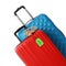 Red and blue suitcases with TRAVEL INSURANCE label on background