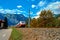 Red blue train in motion in Austrian alps mountains. High speed mountain train arrives at Hallstatt Obertraun train station